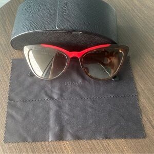Prada women’s black fox sunglasses.